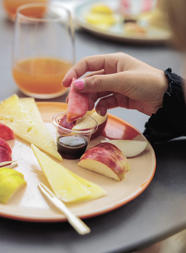 Guests sample the farm’s Pink Pearl Apple Cider and heirloom apples paired with local cheese. Photo: © 2025 Paige Green
